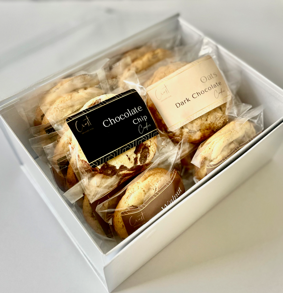 Assorted gourmet cookies featuring a variety of flavors and textures, including classic chocolate chip, pistachio cookie, coffee cookie, hazelnut cookie, macadamia and white chocolate cookie, oats and dark chocolate cookie, walnut milk chocolate cookie, perfect for any sweet craving