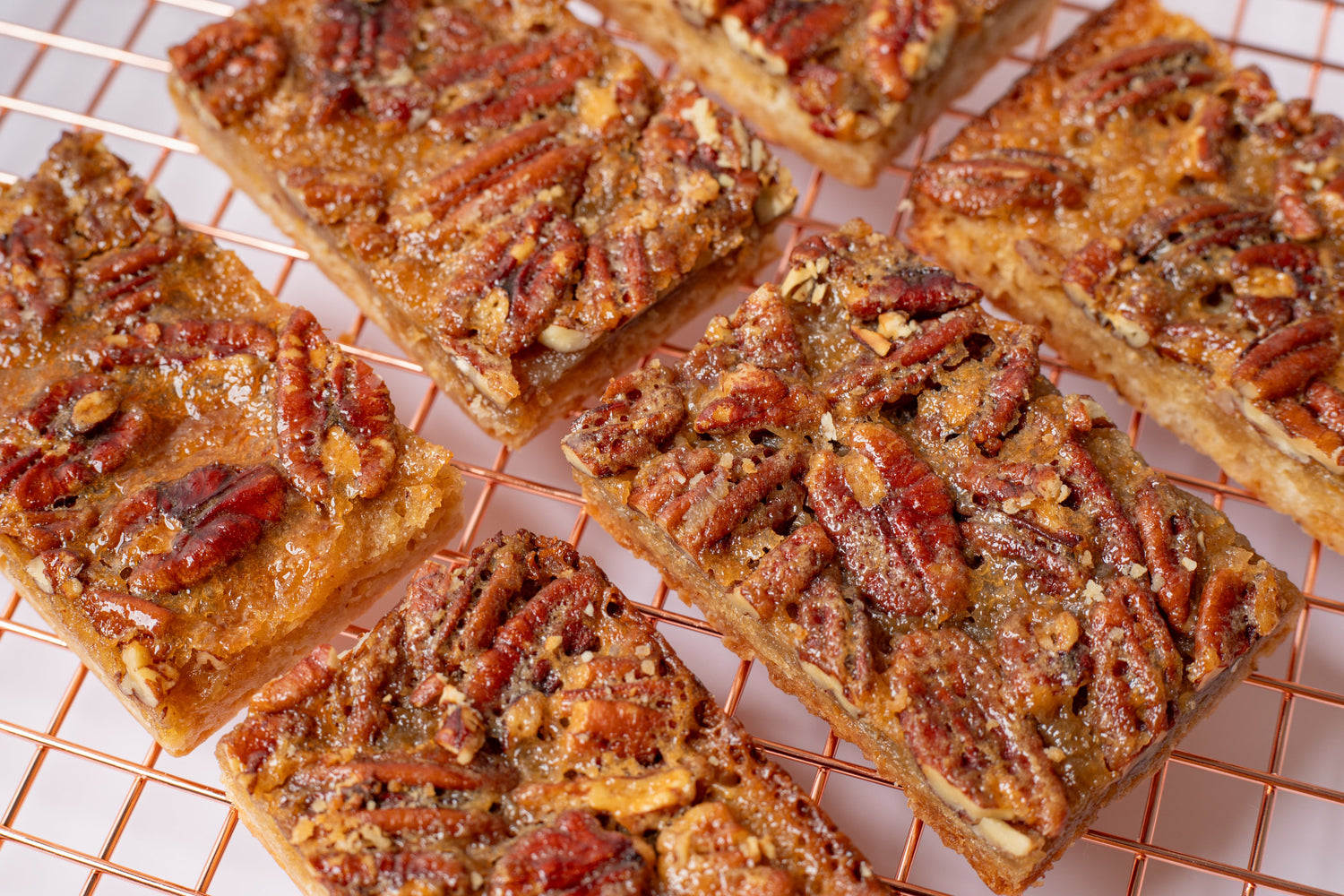 Delicious pecan bar with a buttery shortbread crust, topped with a rich caramel pecan filling—just like pecan pie in a convenient, handheld treat