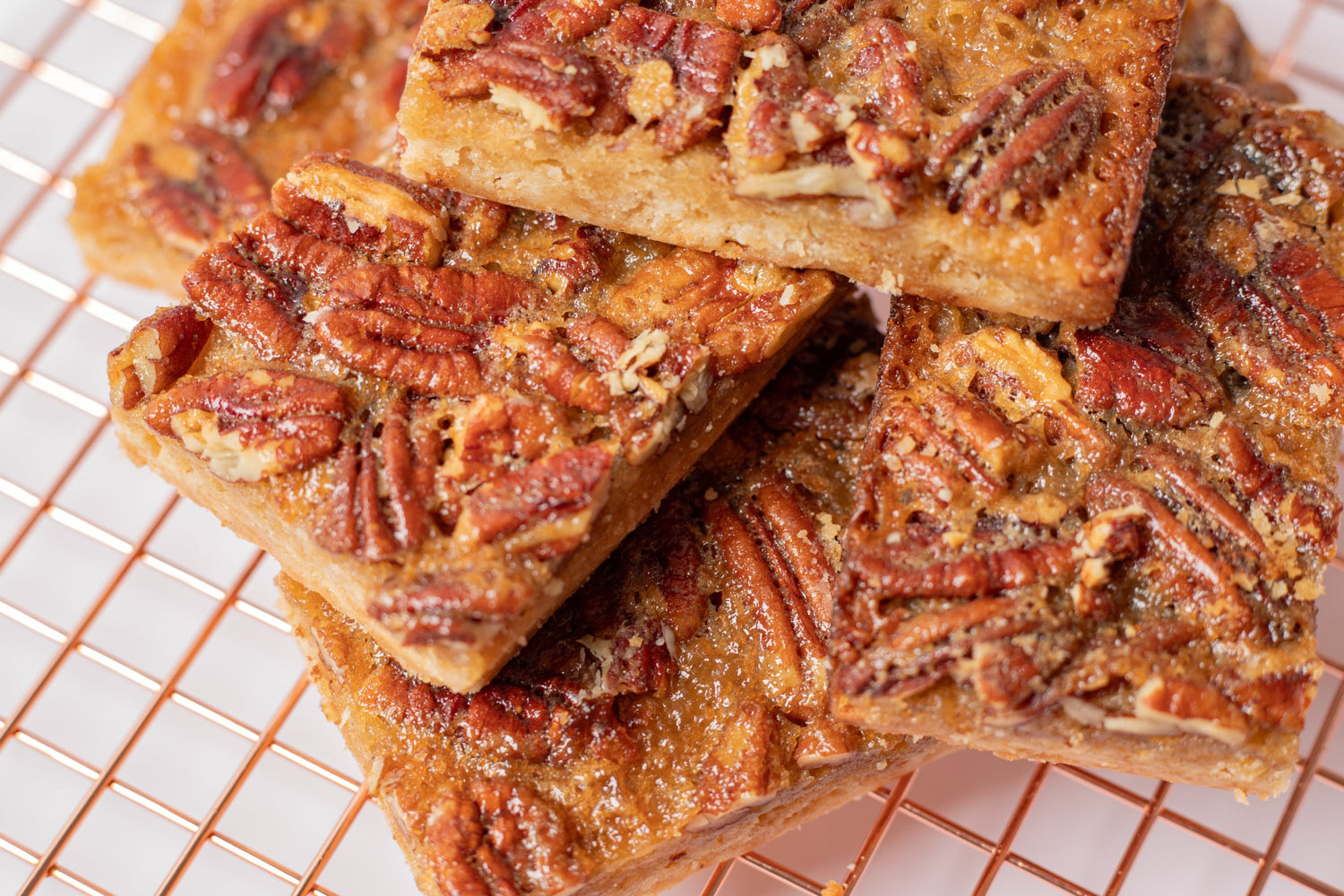 Delicious pecan bar with a buttery shortbread crust, topped with a rich caramel pecan filling—just like pecan pie in a convenient, handheld treat
