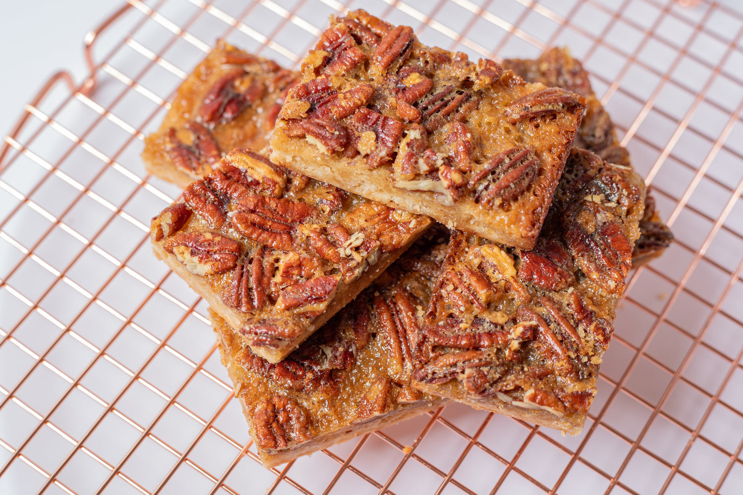 Delicious pecan bar with a buttery shortbread crust, topped with a rich caramel pecan filling—just like pecan pie in a convenient, handheld treat