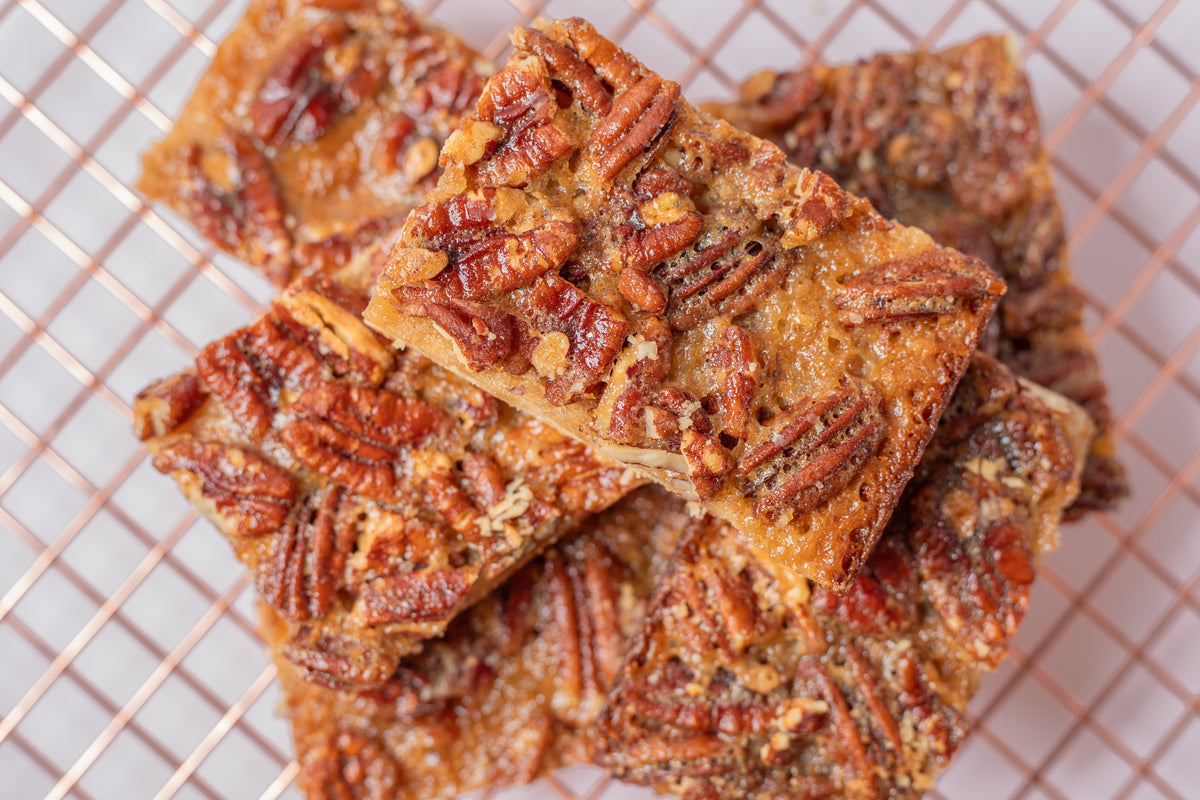 Delicious pecan bar with a buttery shortbread crust, topped with a rich caramel pecan filling—just like pecan pie in a convenient, handheld treat