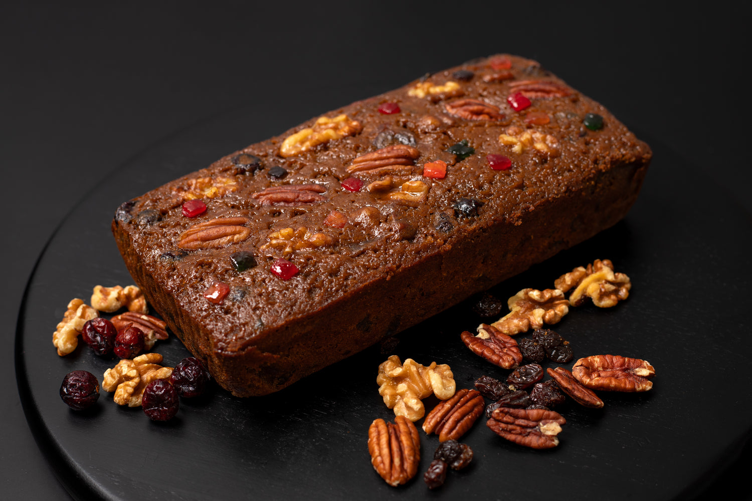 Luxe Fruitcake matured in rum, with caramelized pineapples, cranberries, cherries, raisins, walnuts and pecans.