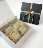 Pistachio cookies in white and black box with ribbon perfect for gifting.