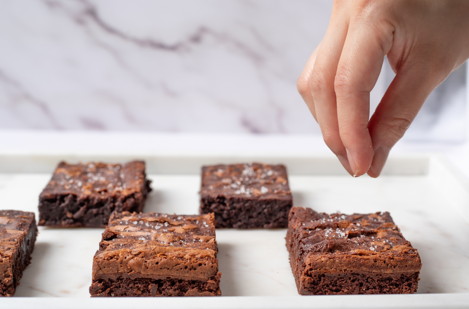 Rich and fudgy brownies with a hint of sea salt, expertly topped with a sprinkle of salt for a perfect balance of sweet and savory flavors in every bite